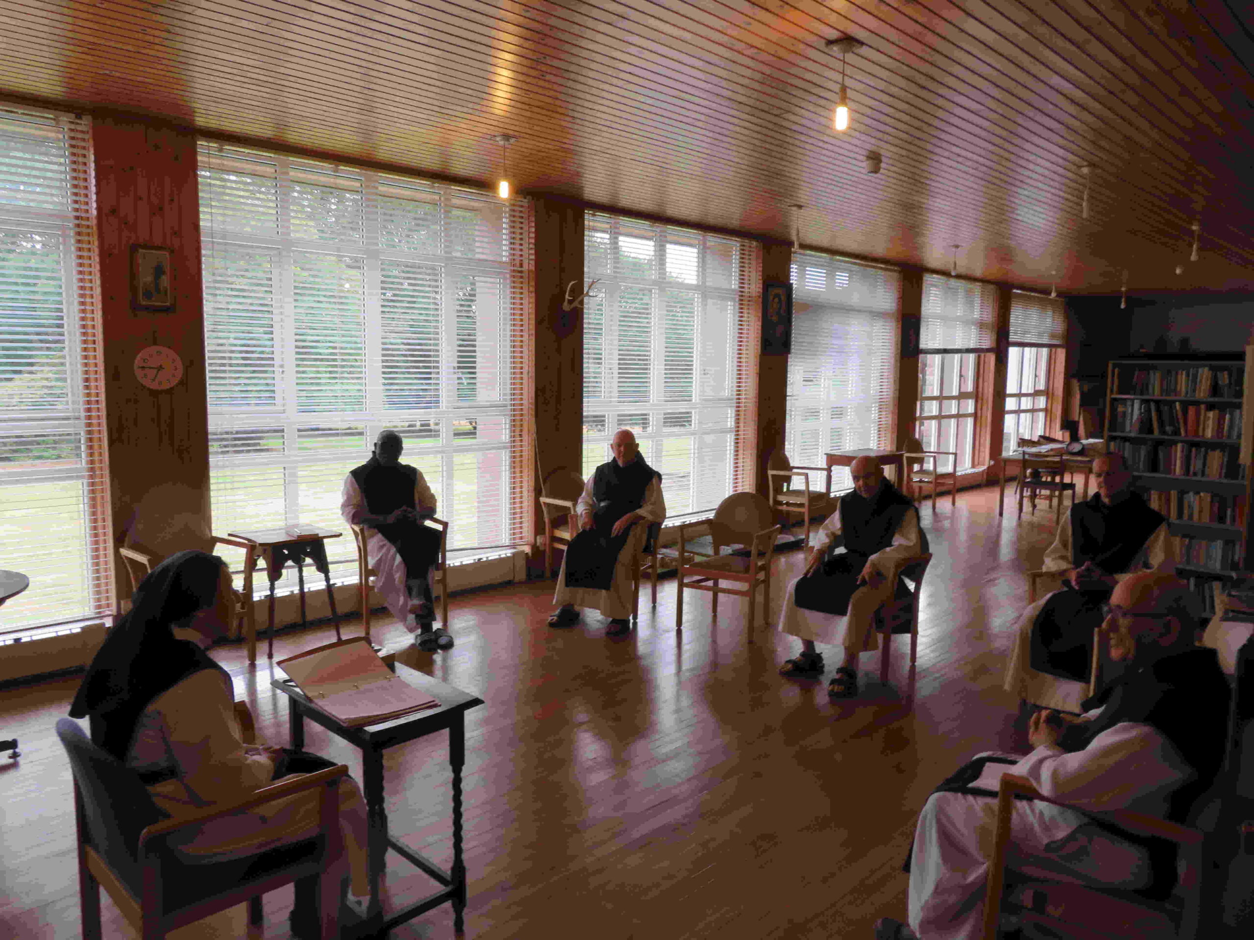 Monks sitting around room